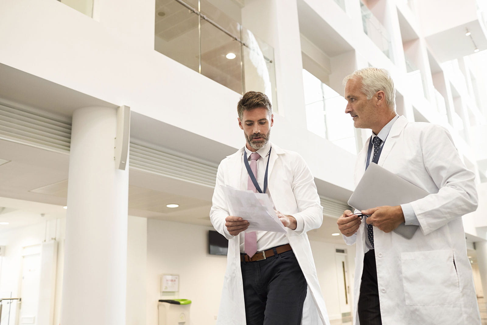 Two scientists walking in a corridor
